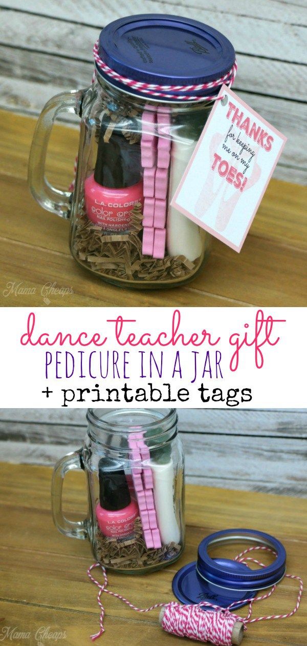 two mason jars with pink and blue ribbon tied to them, one is filled with teacher gifts