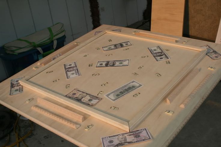 some money is laying on top of a piece of plywood