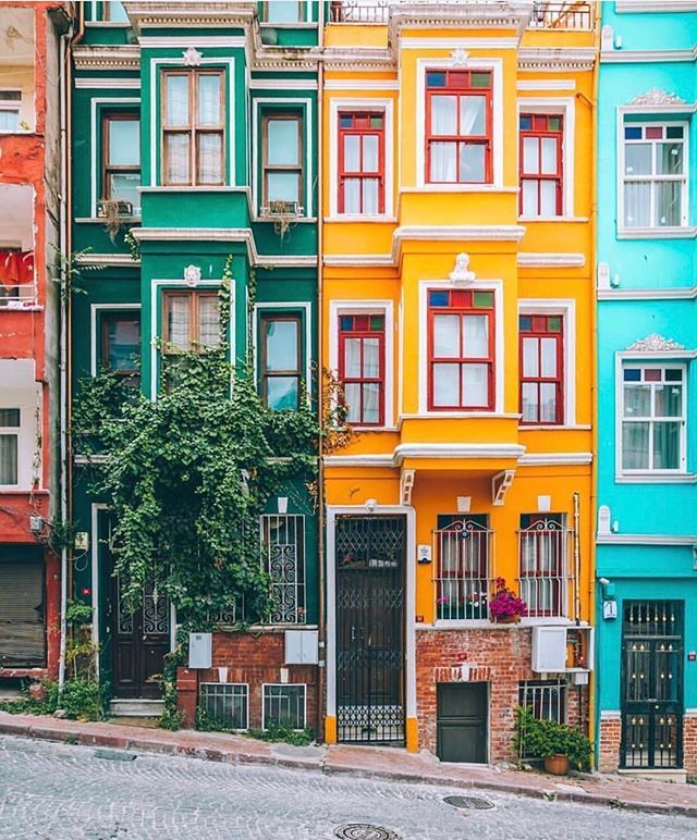 several multicolored buildings line the side of a street