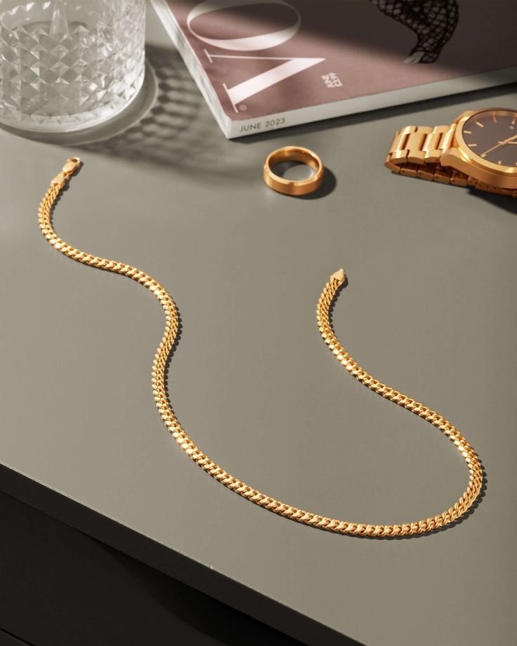 Start your chain collection with our gold 5mm Cuban Link Chain. This iconic chain boasts the perfect weight and shine for the piece you’ll wear day after day. The 5mm Cuban Link Chain is JAXXON’s best-selling chain for a reason. Make it the staple in your collection. Mens Luxury Accessories, Gold Cuban Chain, Gold Cuban Link Chain, Gold Bond, Gold Chains For Men, Solid Gold Chains, Silver Coat, Gold Piece, Silver Shop