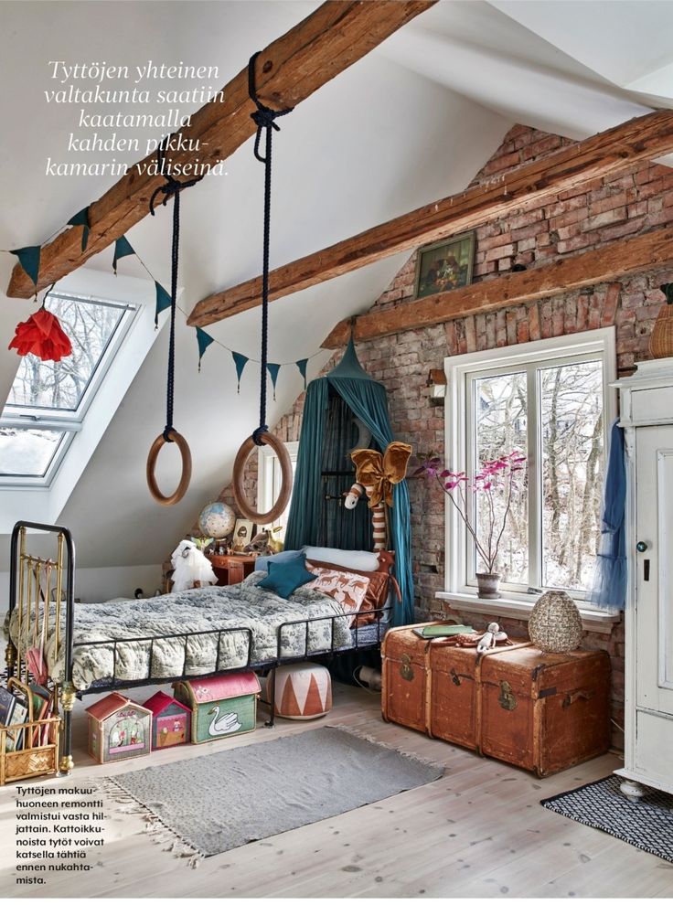 an attic bedroom with exposed brick and wooden beams, bedding, rugs and other accessories