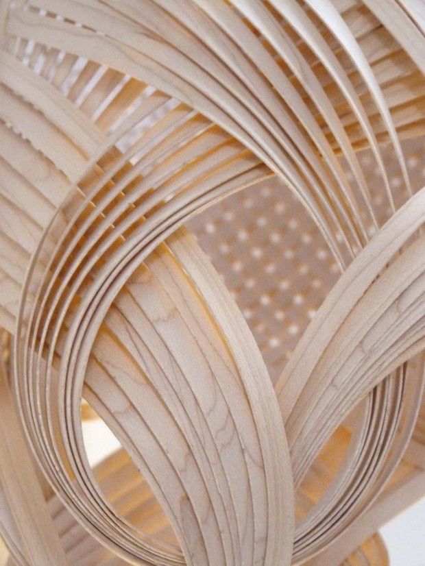 an abstract sculpture made out of wooden strips