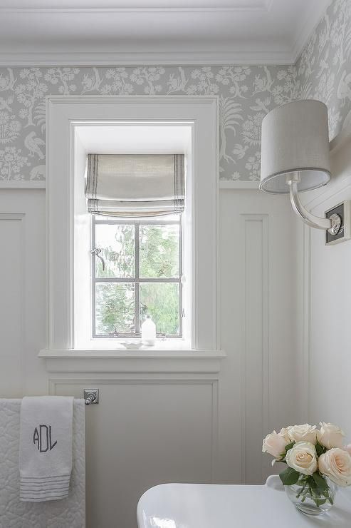 a white bathroom with a star decoration on the window sill