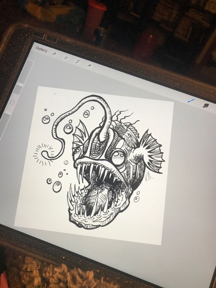 a computer screen with a drawing of a fish on it's face and mouth