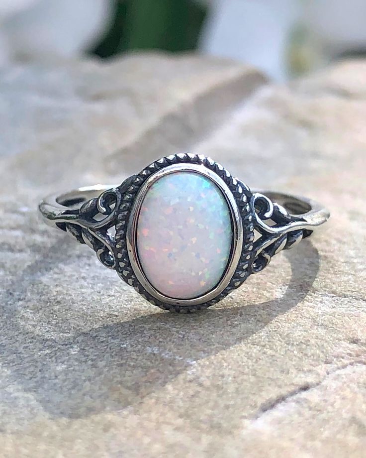 Sterling Silver Oval White Lab Opal Ring | The Life Divine Sterling Silver Oval White Lab Opal RingCherished for its brilliance, Opal is known as a stone of creativity and vitality. Opal is also a reflective stone of protection, absorbing energies and sending them back to their source.Measures approximately 3/8" H x 1/2" W Adjustable White Oval Crystal Ring, Spiritual Oval Opal Birthstone Ring, Adjustable Oval Opal Ring With Stone Setting, Adjustable Opal Crystal Ring, Oval Shape, Adjustable Opal Oval Crystal Ring, Adjustable Oval Opal Crystal Ring, Oval Opal Rings With Spiritual Style, White Oval Crystal Ring With Large Stone, Spiritual Oval Opal Promise Ring