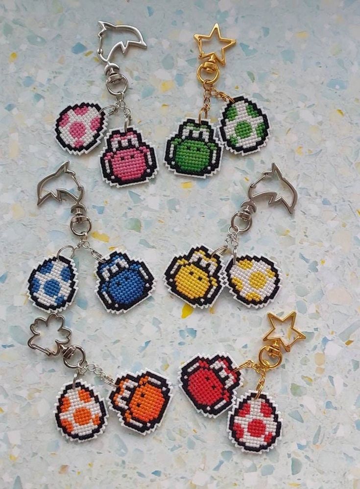 the pixel keychains are all made up of different colors and shapes, including one with