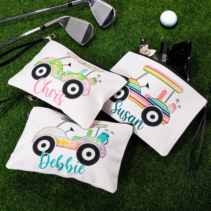 two personalized golf bags on the grass with clubs and balls in the back ground