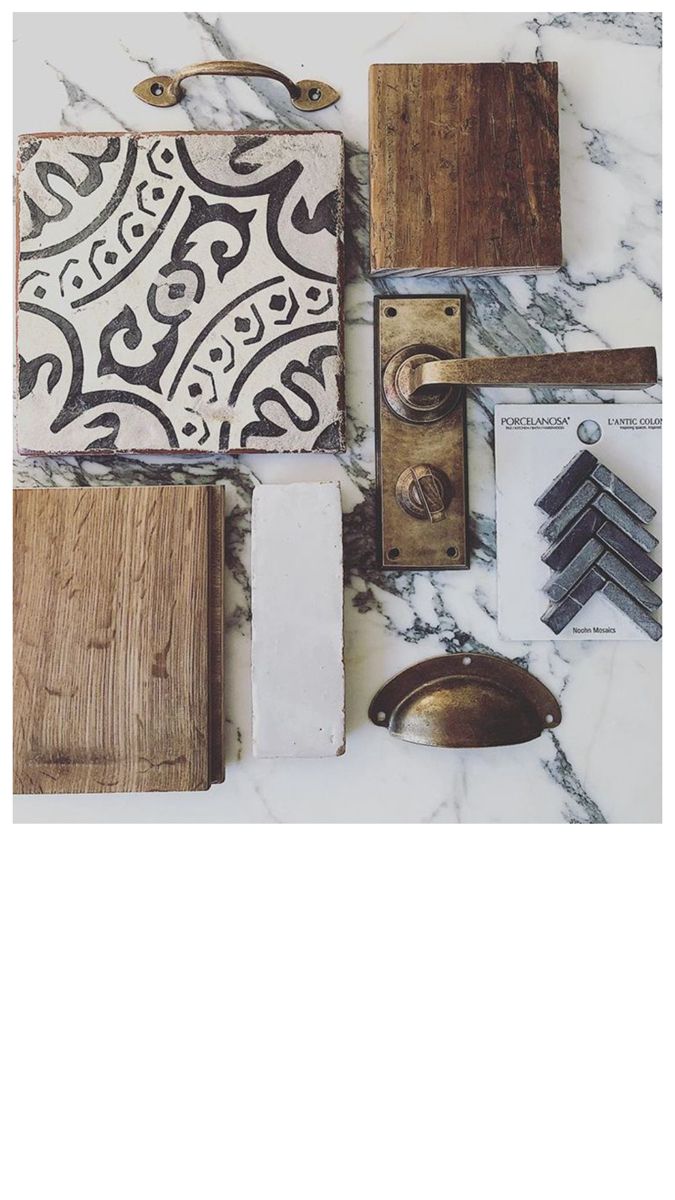 various wood and tile items on a marble counter top, including an iron door handle