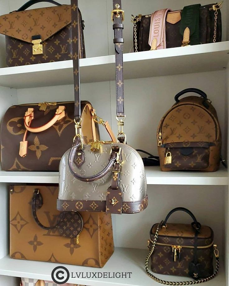 several purses and handbags on shelves in a room with white shelve