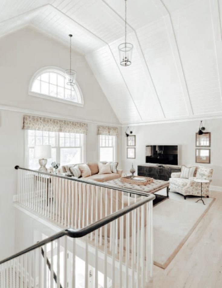 a living room filled with furniture and windows