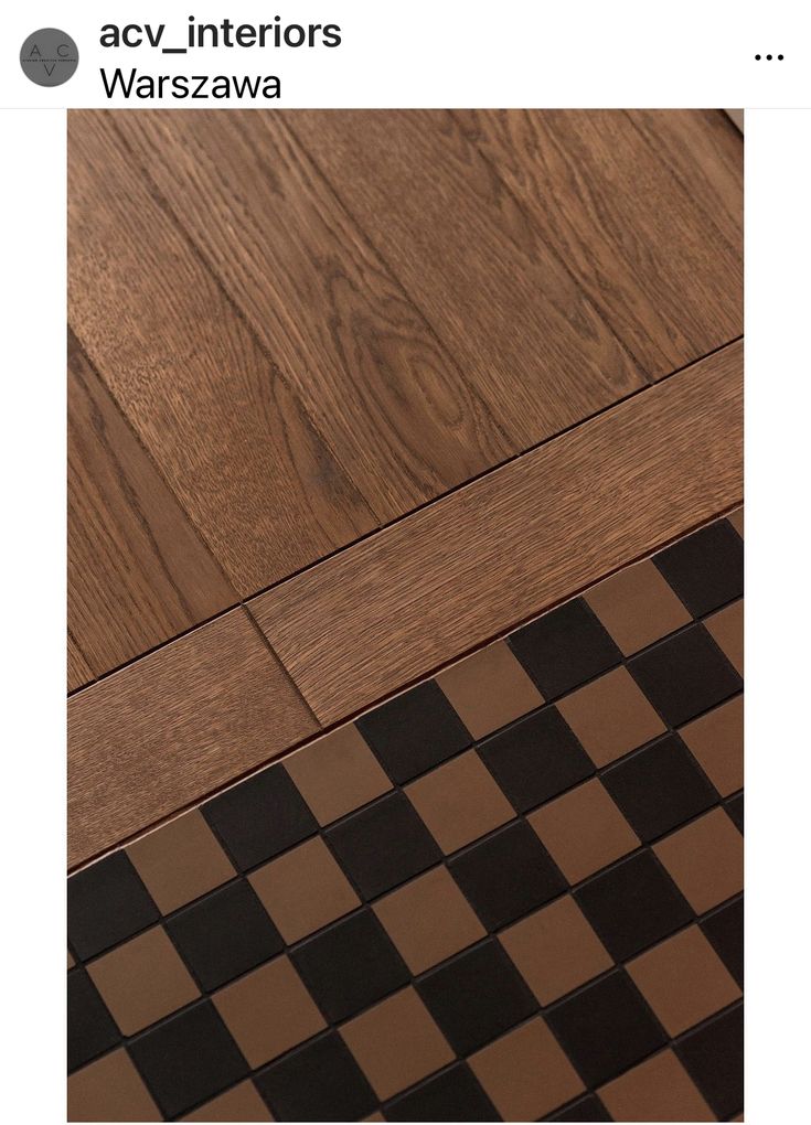 a wooden floor with black and white checkered tile on the bottom, and an advert