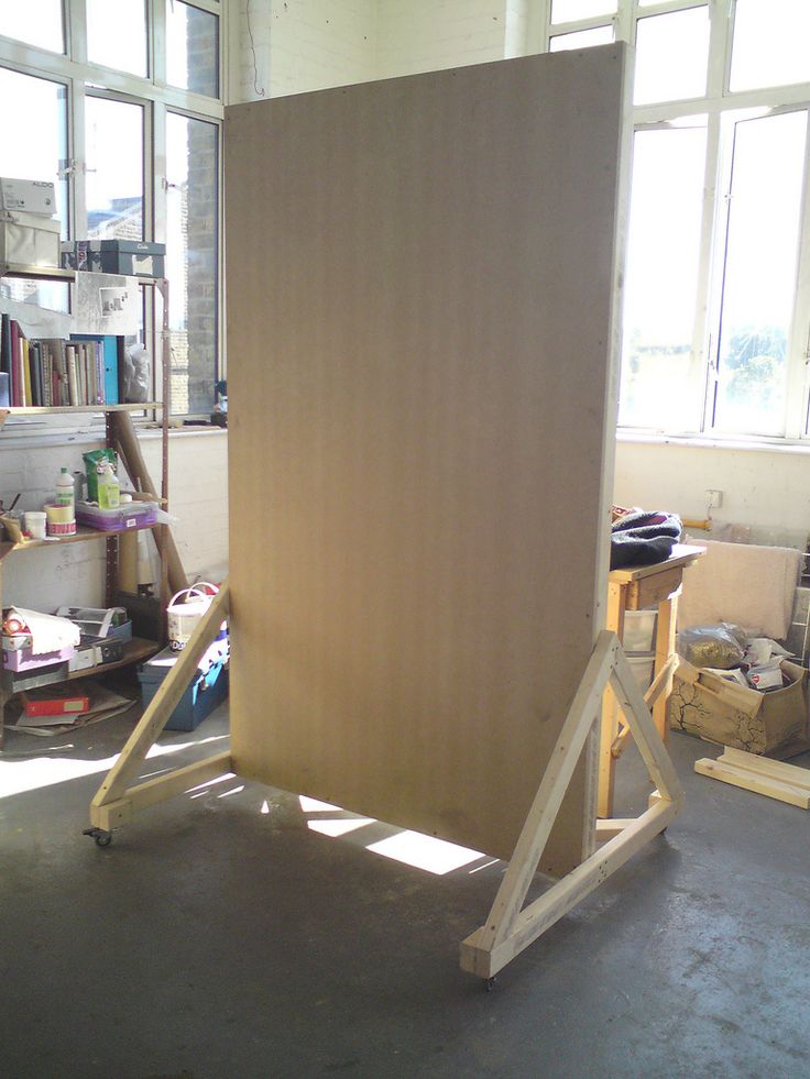 an easel is sitting in the middle of a room