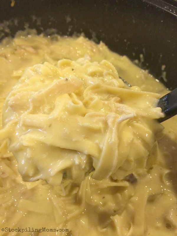 a pot filled with pasta and sauce on top of a stove