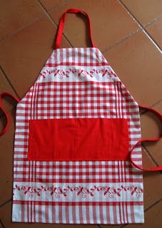 a red and white checkered apron sitting on the floor