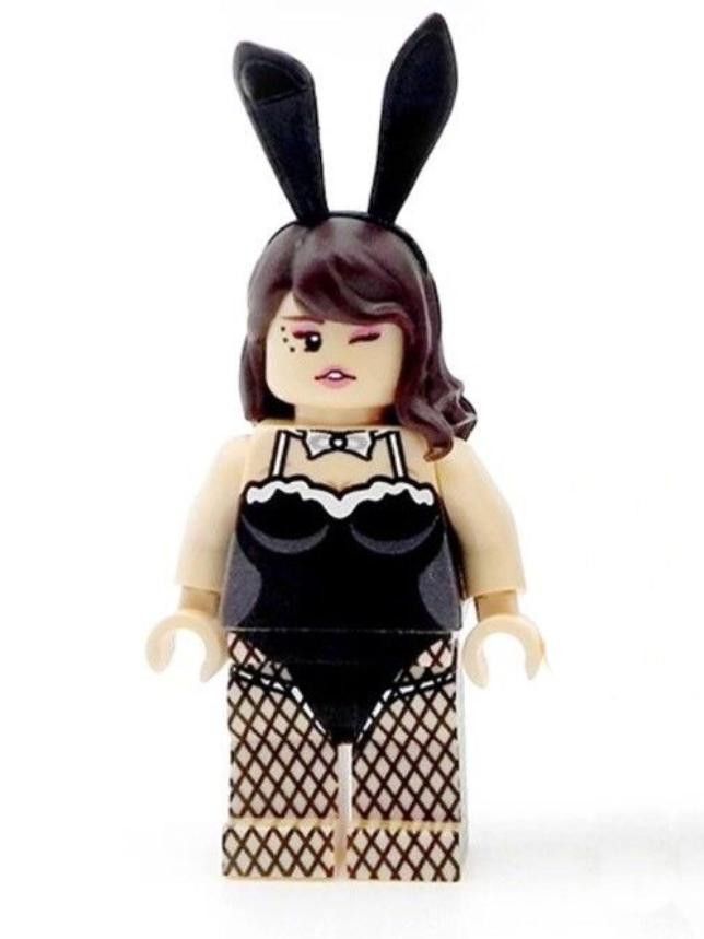 a lego figure with black and white clothing on it's head, wearing bunny ears