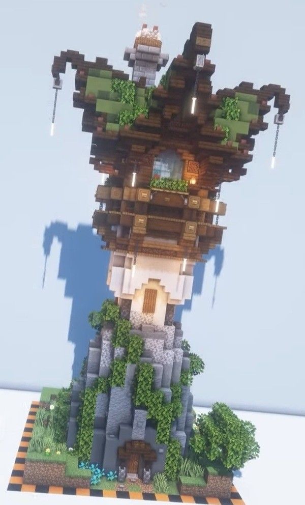 a very tall tower with lots of trees on it's sides in the sky