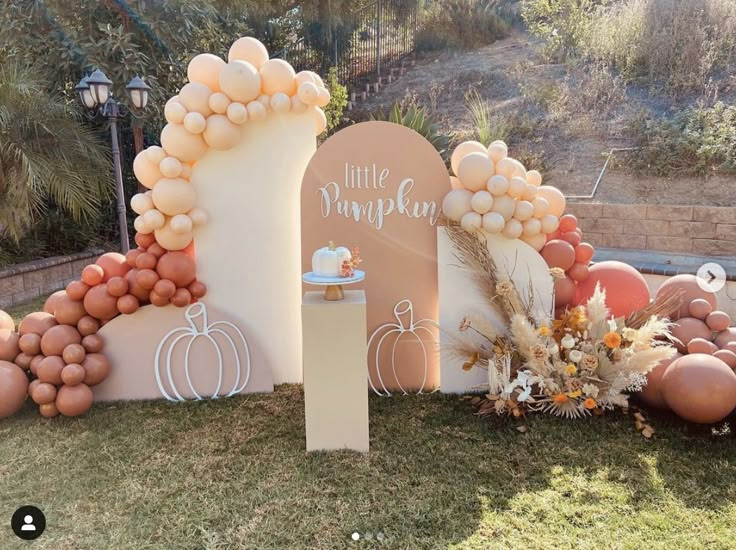 an outdoor display with balloons and pumpkins