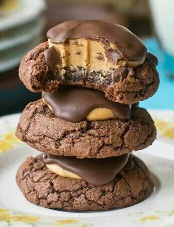 three cookies stacked on top of each other with chocolate frosting and peanut butter in the middle