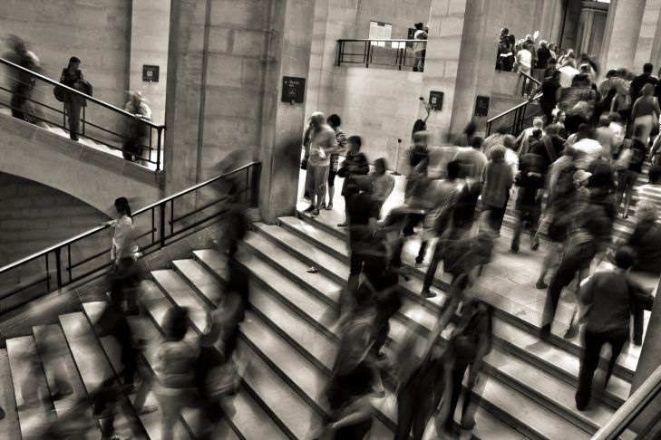 many people are walking up and down the stairs