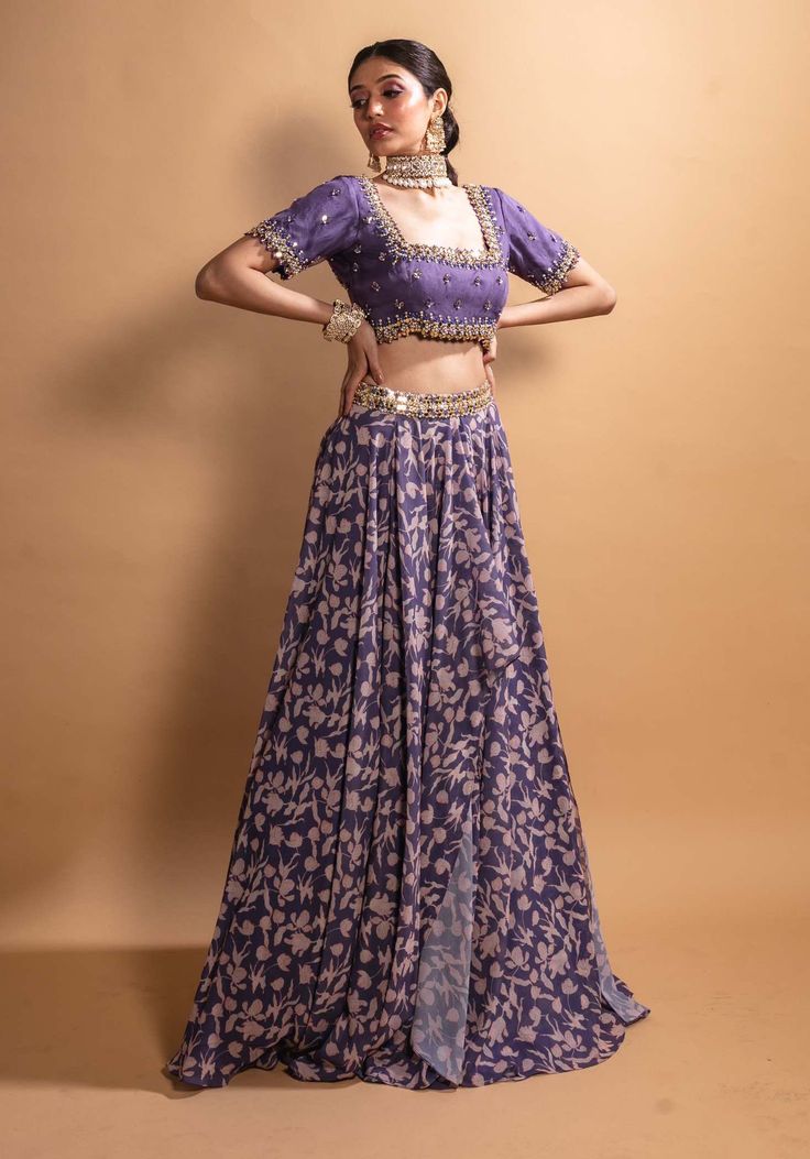 Editor's Note Featuring A Purple Printed Georgette Double Layer Lehenga With A Full Embroidered Blouse And An Organza Dupatta Color: Purple Fabric: Poly Georgette Care: Dry Clean Only About the Designer Ria Shah Label Houses Womenswear Based On The Concept Of Affordable Luxury. The Idea Is To Empower Women With Clothing That Will Definitely Make A Statement And Yet Be Easily Accessible I.e. Not Break The Bank Double Layered Lehenga, Layer Lehenga, Layered Lehenga, Printed Lehenga, Indian Designer Suits, Indian Wedding Wear, Lehenga Blouse, Floral Squares, Organza Dupatta