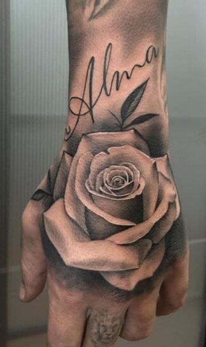 a person's hand with a rose tattoo on it and the word aluna written in cursive writing