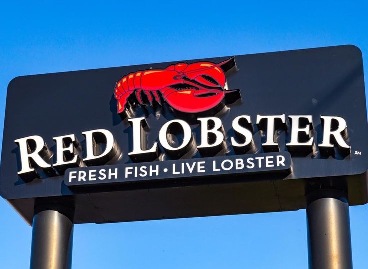 a red lobster sign is shown against a blue sky