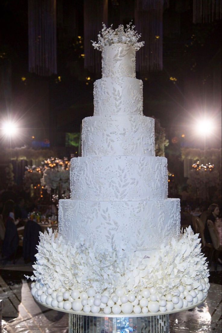 a large white wedding cake sitting on top of a table