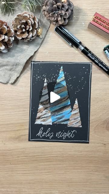 a wooden table topped with pine cones and markers