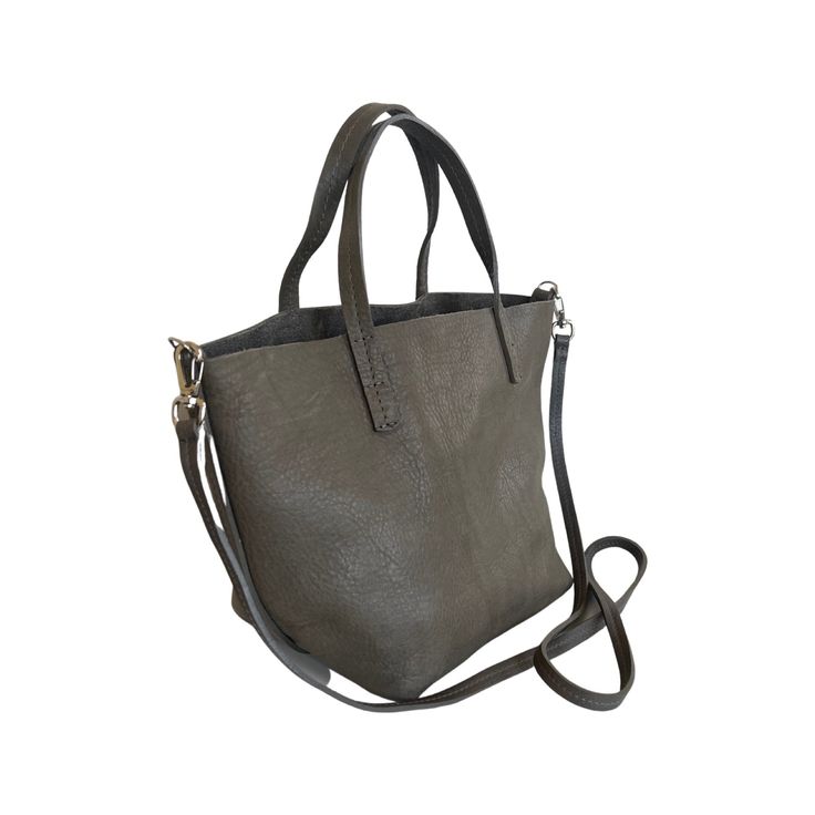 Soft, thick Argentinian small leather tote bag with short strap that sits under the arm. This tote style leather bag features an interior removable pouch which sections the bag, and a pocket. This tote is available in 3 colors. - Measures 8”H X 13 1/2”W X 7” D- 5” Handle Drop Inside pouch- 7 1/2”H X 12” X 5”D - 45” extra long strap . On-the-go Top Handle Bucket Bag, Chic Handheld Satchel With Textured Leather, On-the-go Bucket Bag With Leather Handles, Handheld Textured Leather Travel Bag, Chic Handheld Textured Leather Shoulder Bag, Double Handle Textured Leather Satchel, Everyday Satchel With Detachable Handle, Modern Soft Leather Satchel For On-the-go, Tote Shoulder Bag With Detachable Strap For Shopping