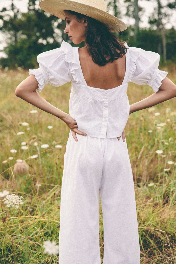 Introducing our name sake piece the Arden top, a playful take on a young girlish shape, featuring sweet ruffle details on oversized puff sleeves evoking feelings of fresh spring blooms with romantic notes, yet can easily be worn everyday. Made in cloud soft organic hemp that only gets better with time. Cut in a slightl Feminine Puff Sleeve Blouse For Garden Party, Summer Puff Sleeve Blouse For Garden Party, Feminine Ruffled Tops For Garden Party, Feminine Ruffle Tops For Garden Party, Spring Garden Party Tops With Puff Sleeves, Balloon Sleeve Tops With Ruffles For Day Out, Spring Garden Party Puff Sleeve Tops, Billowy White Summer Blouse, Billowy White Blouse For Summer