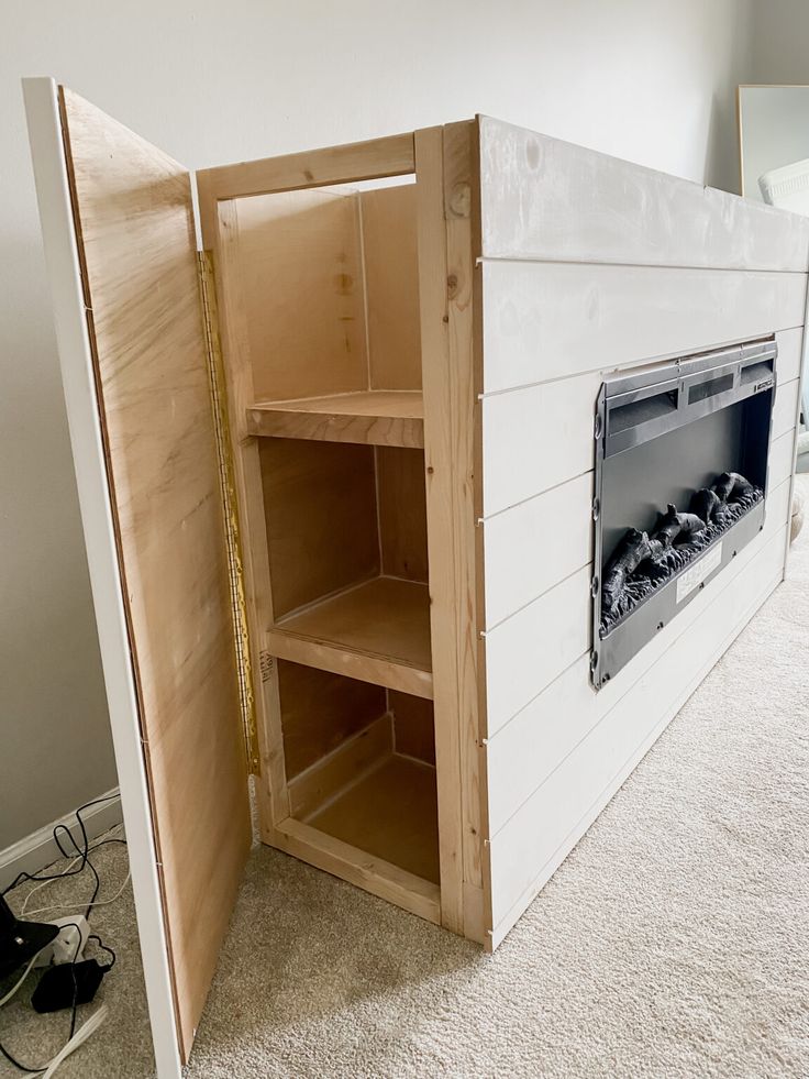 an empty room with a fireplace built into the wall and shelves in front of it