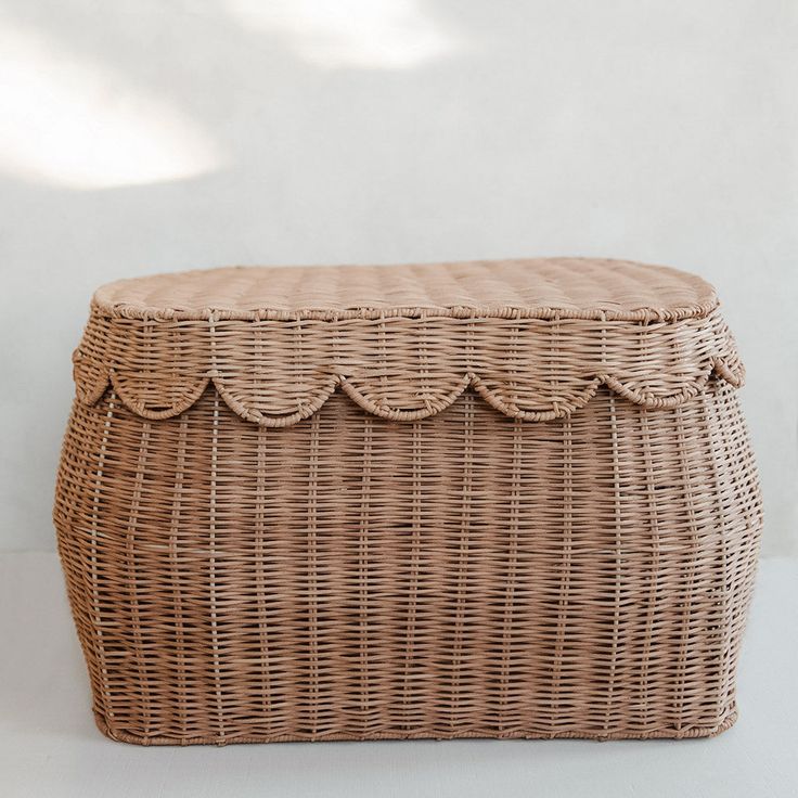 a large wicker basket with scalloped edges on a white background, the lid is closed