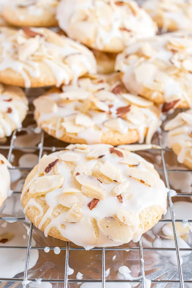 a cooling rack filled with cookies covered in icing