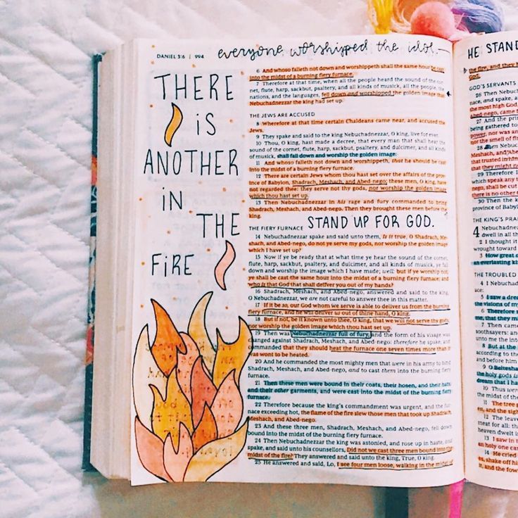 there is another in the fire bible open on a bed with colorful crayons