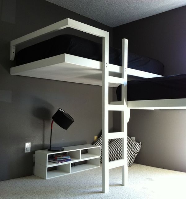 a bunk bed sitting next to a white desk in a room with carpeted flooring