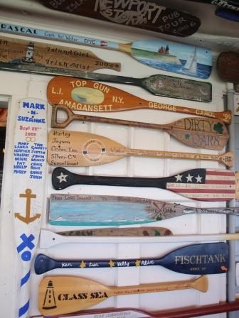 there are many different types of paddles on the wall in this shopfront window