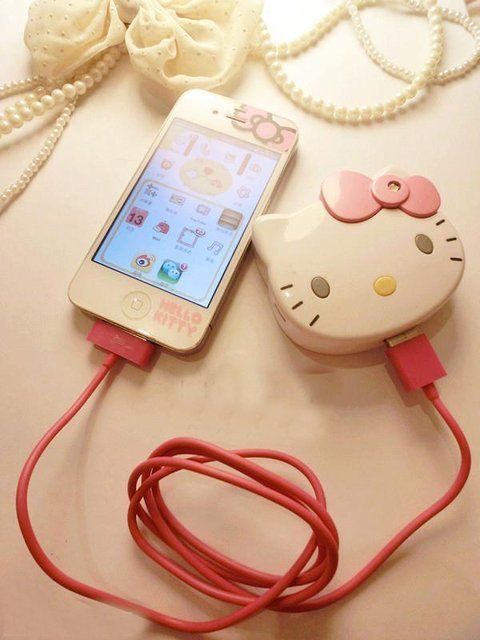 a cell phone plugged into a charger with a hello kitty design on it