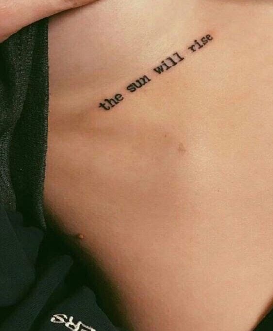 the back of a woman's stomach with an inscription on it that says, the sun will rise