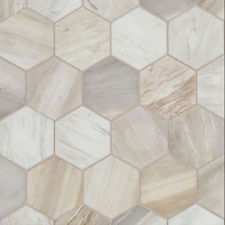 a close up view of a marble tile wall with hexagon tiles on it