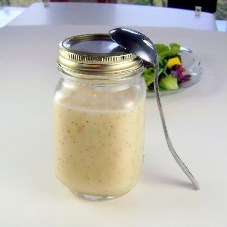 a glass jar filled with food sitting on top of a table next to a plate