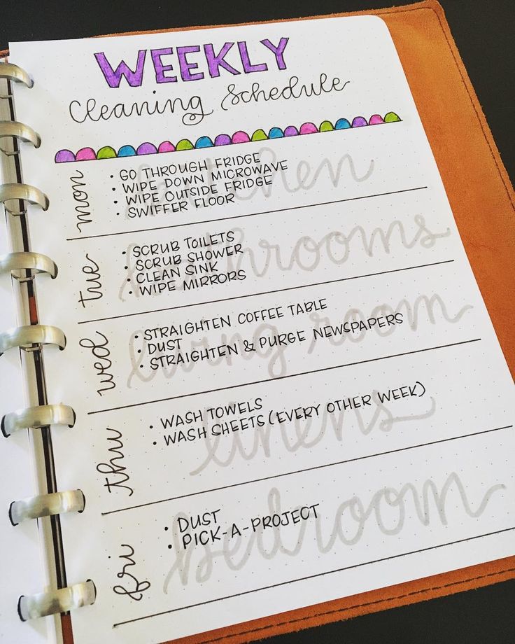 a planner with the words weekly cleaning schedule written in cursive writing on it