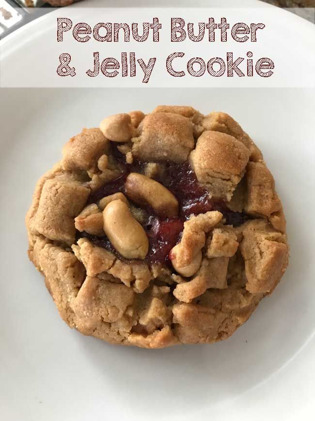 a peanut butter and jelly cookie on a white plate with the title in the middle