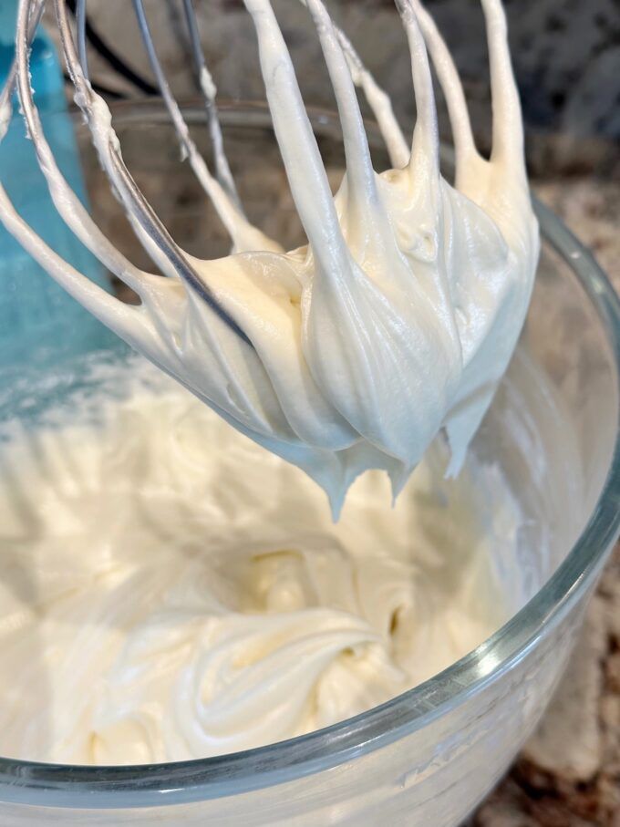 cream cheese sour cream frosting in a mixing bowl