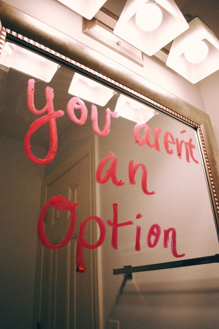 a mirror with writing on it that says you are not an option in red ink