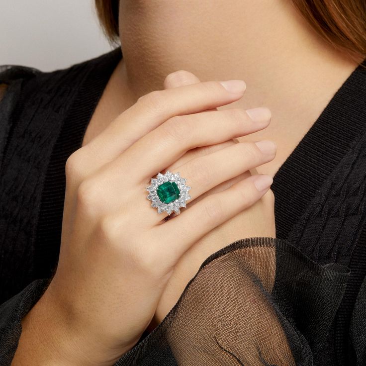 One of a Kind Ring. Outer diameter of ring measures 22mm x 22mm. Center stone Emerald measures 10mm x 10mm. Emerald sourced from Zambia. SKU ASRW4237 Carat Weight 4.72ct Emerald || 4.27ct Diamond Metal Type 18KT White Gold Primary Stone Emerald Weight 6.57g Color Grade H Clarity VS Luxury Gia Certified Diamond Gemstones, Luxury Cluster Diamond Ring With Gemstone, Luxury Gia Certified Gemstones, Luxury White Gold Gia Certified Gemstones, Luxury Gia Certified White Gold Gemstones, Luxury Round Cut Gemstones With Center Stone, Luxury Round Cut Center Stone Gemstones, Gia Certified Cushion Cut Fine Jewelry, Luxury Emerald Ring In Diamond White As Gift