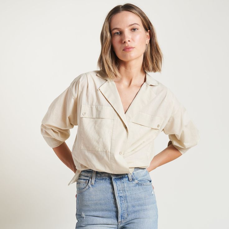 The Fay Boyfriend Shirt is roomy and relaxed but decidedly feminine and sophisticated. Crafted from cotton lawn, a lightweight yet durable fine thread poplin, the Faye has a silky-smooth hand feel. Its unique features include a lay-flat camp collar with an elevated top button and loop closure, wide-set pleated center front placket, and exquisite topstitching details on the sleeve placket and cuff. 100% Cotton Button flap patch pockets at the chest High side-slits at the hem for a fashionable tuc Beige Camp Collar Shirt For Spring, Effortless Everyday Tops With Spread Collar, Effortless Everyday Top With Spread Collar, Oversized Lapel Collar Blouse For Spring, Oversized Blouse With Lapel Collar For Spring, Relaxed Fit Blouse With Roll-up Sleeves For Spring, Relaxed Collared Blouse For Daywear, Effortless Daywear Shirt With Rolled Sleeves, Effortless Blouse With Rolled Sleeves