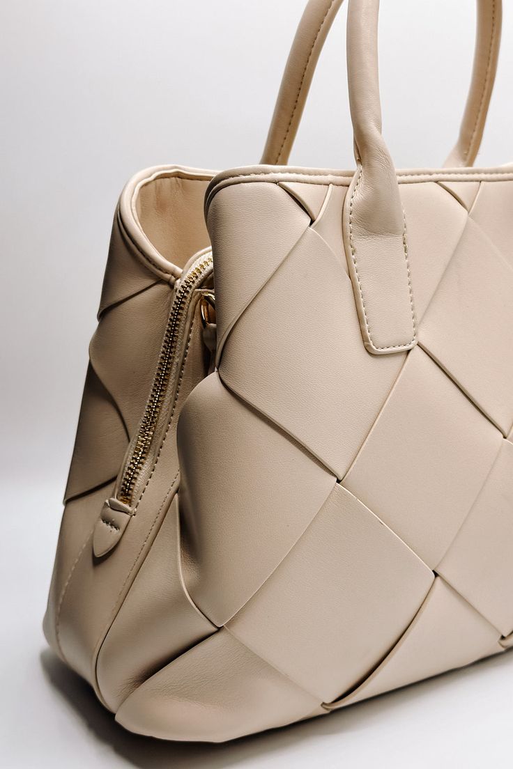 Close up side view of the Phoebe Cream Woven Leather Purse which features cream leather fabric, woven pattern details, gold hardware, monochrome straps, zipper closure and gold clasp closure Luxury Textured Leather Box Bag, Beige Structured Bag For Formal Occasions, Beige Structured Formal Bag, Luxury Beige Structured Shoulder Bag, Luxury Structured Beige Shoulder Bag, Formal Structured Beige Bag, Cream Clutch Bag With Zipper Closure, Structured Beige Bags For Daily Use, Beige Structured Bag For Daily Use