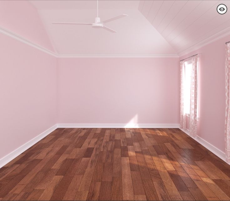 an empty room with pink walls and wood floors