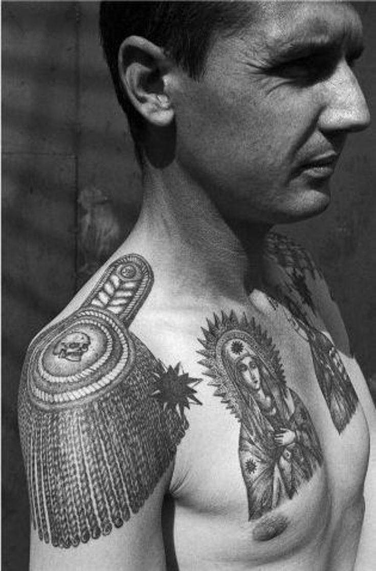 a man with many tattoos on his chest