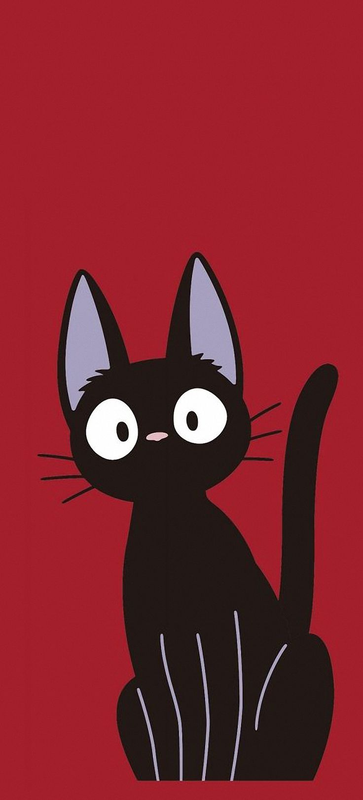 a black cat sitting on top of a red background